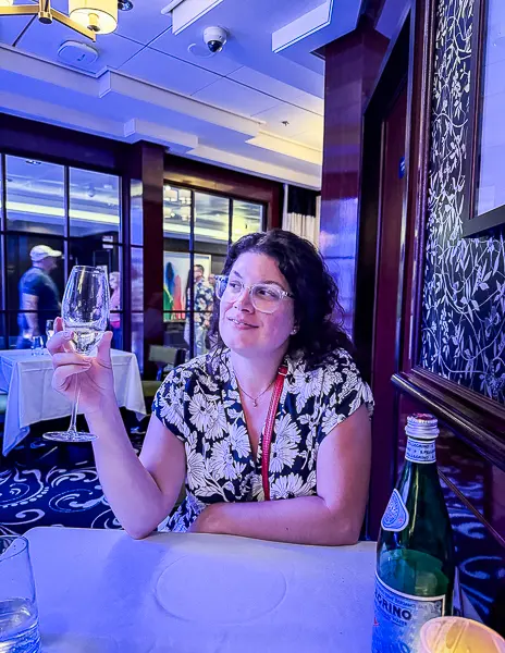 Kathy enjoying a glass of wine at Le Bistro, showcasing the elegant and intimate dining atmosphere.