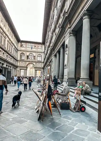 Artists displaying their work in the courtyard of the Uffizi Gallery in Florence, Italy.