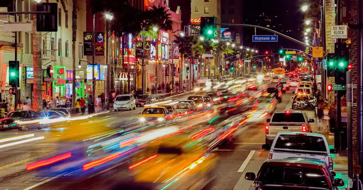 A vibrant night scene of Hollywood Boulevard showcasing Los Angeles attractions with bright lights and bustling traffic.