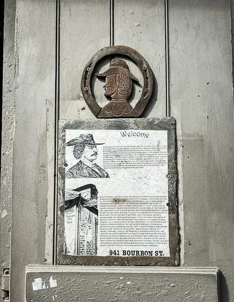 Historical plaque at Lafitte's Blacksmith Shop Bar in New Orleans, detailing the history of the legendary pirate Jean Lafitte.