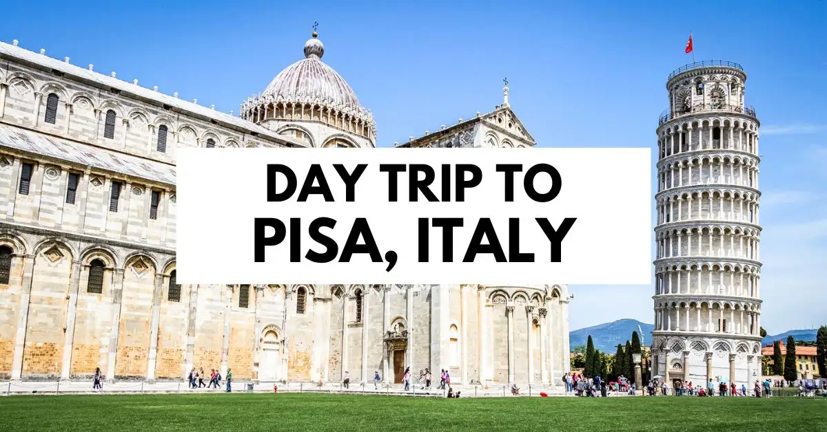 featured blog image is a single wide-angle shot showcasing both the Pisa Cathedral and the Leaning Tower of Pisa. The entire scene is set against a clear blue sky, with the text "Day Trip to Pisa, Italy" overlaying the image.