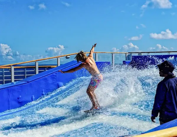 Person surfing on the FlowRider aboard a Royal Caribbean cruise ship.