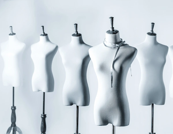 Multiple unclothed mannequins arranged in a row against a light background to represent revealing clothing