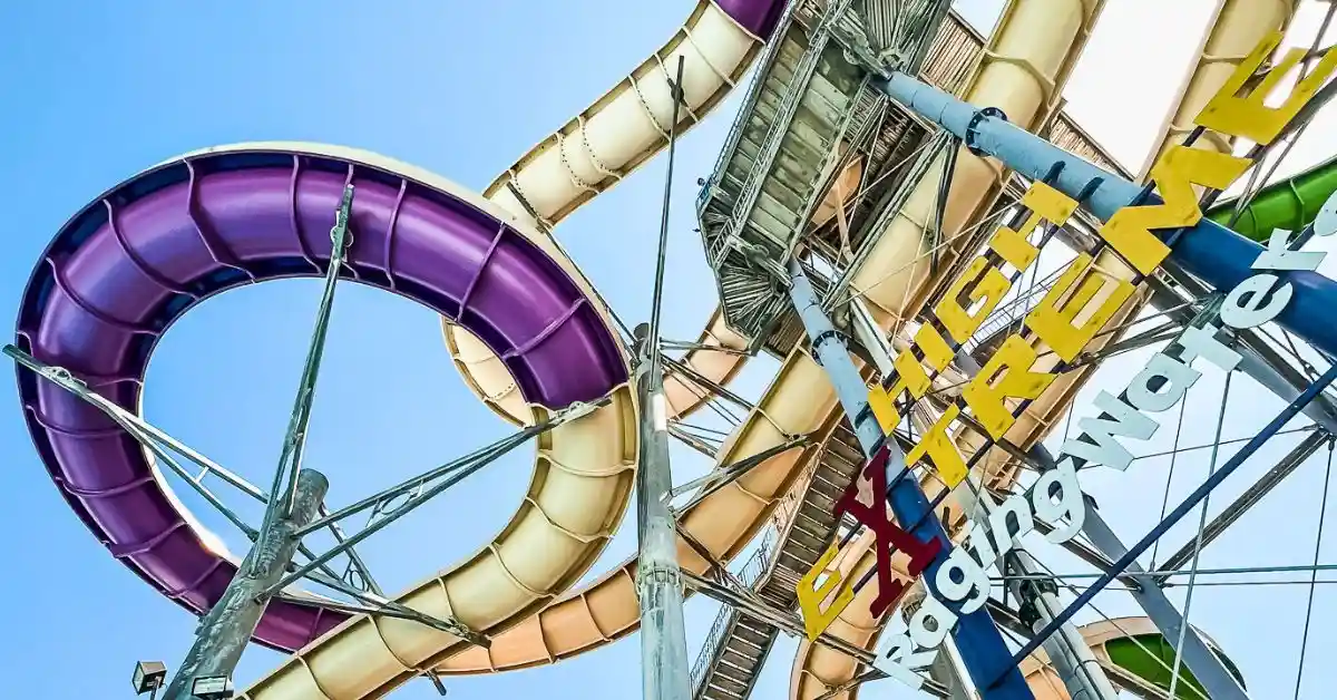 featured blog image of colorful water slides looping around each other at Raging Waters Los Angeles under a sunny blue sky