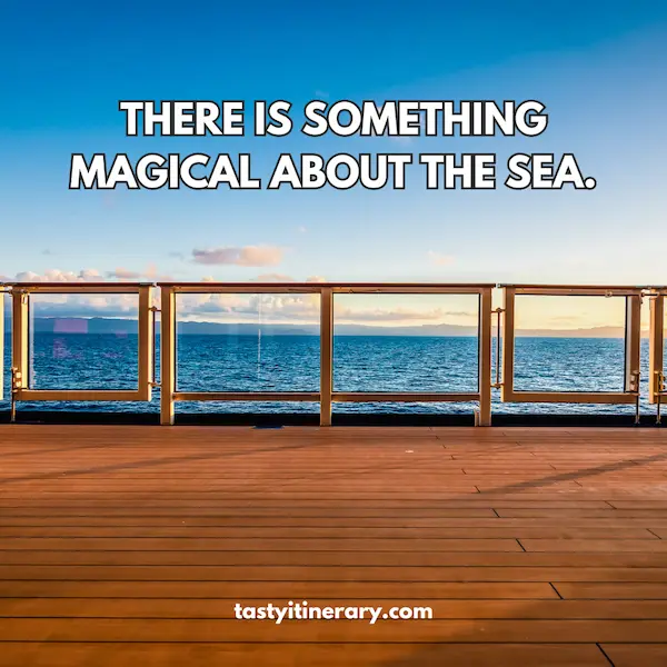 View from a cruise ship deck overlooking the ocean with the quote "There is something magical about the sea." written in bold letters, with a clear blue sky and calm sea in the background.