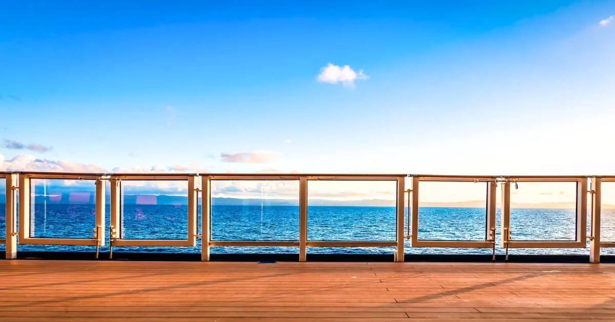 Featured blog image of the ocean view from a cruise ship deck under a clear blue sky, ideal for first-time cruisers tips.