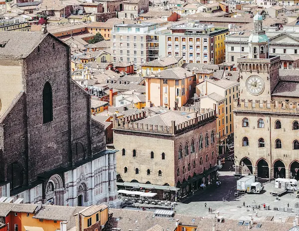 Aerial view of Piazza Maggiore in Bologna, showcasing the Basilica of San Petronio, historic buildings, and the vibrant cityscape