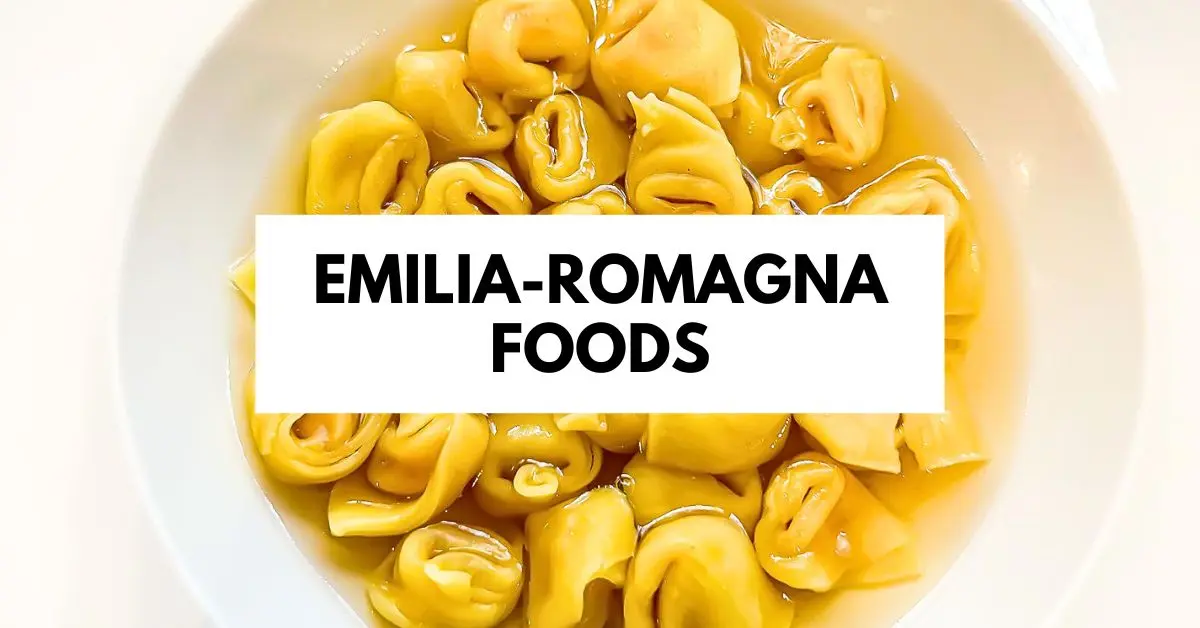 A close-up of tortellini en brodo, featuring golden tortellini pasta in a clear broth. The overlay text reads "Emilia-Romagna Foods," highlighting the traditional cuisine of this Italian region.