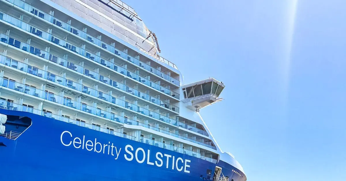 Close-up view of the Celebrity Solstice cruise ship under a clear blue sky, highlighting the ship's exterior and balconies