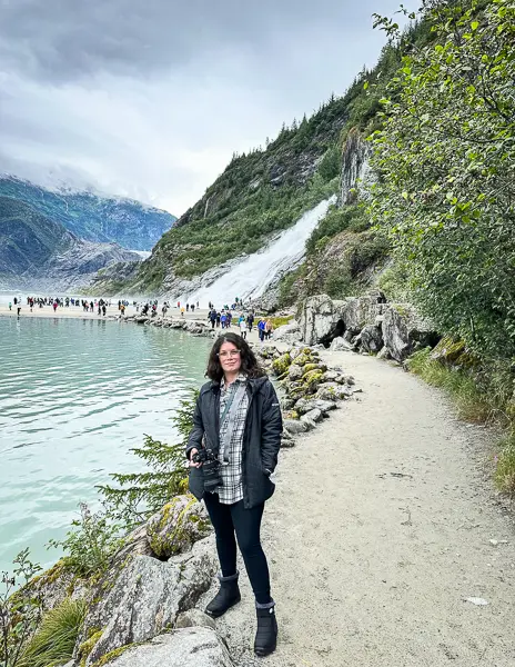 standing on the Nugget Falls Trail in Juneau, with the glacier visible in the distance and the path winding along the shoreline.
