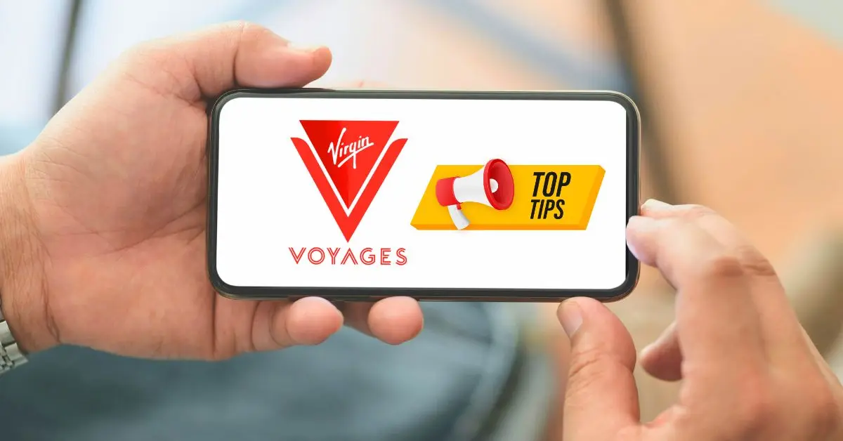 featured blog image A person holding a smartphone horizontally with both hands, displaying the Virgin Voyages logo and the words "VOYAGES TOP TIPS" in a banner across the bottom