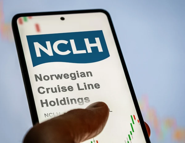 a smartphone screen displaying the logo of Norwegian Cruise Line Holdings (NCLH) with a stock price chart in the background, indicating the user is viewing NCLH's stock information on their device.