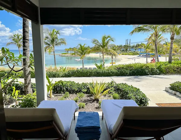 View from a villa terrace at Silver Cove, with loungers overlooking the lagoon.