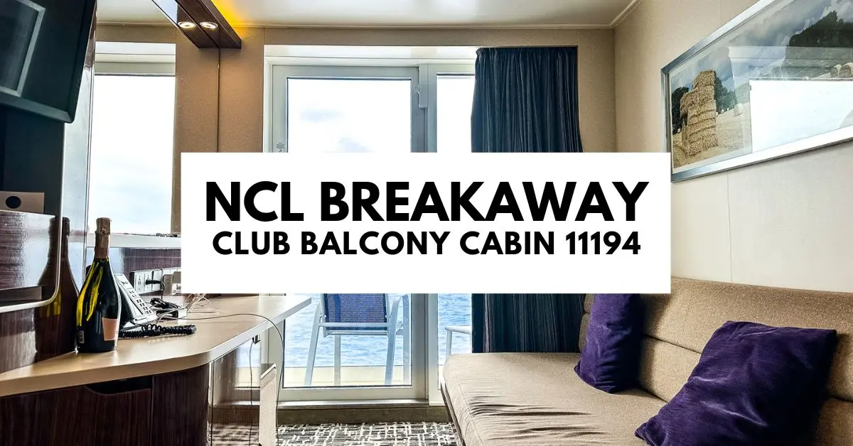 featured blog image hows the interior of the NCL Breakaway Club Balcony Cabin 11194. The room is equipped with modern furnishings including a small sofa, a desk with a chair, a bottle of champagne, and a wall-mounted telephone. Large windows provide a view of the ocean, and there's a glass door leading to the balcony. The decor is completed with a piece of artwork hanging on the wall and curtains drawn to one side.