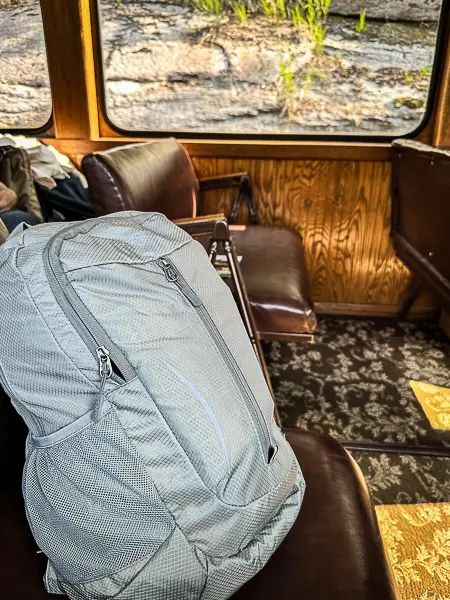 Backpack on a seat inside a transport vehicle during a day out in port.