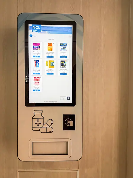 First-aid vending machine on the Norwegian Getaway, displaying a touchscreen interface with medical items such as pain relievers, bandages, and cold medicine for purchase.