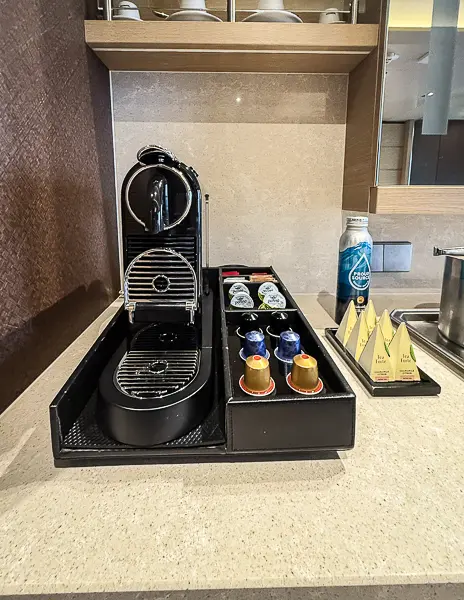 Close-up of the Nespresso machine and coffee pod selection in the Norwegian Getaway Haven Penthouse Suite 14138.