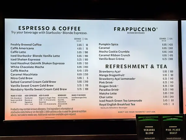 Starbucks menu displayed onboard the Norwegian Getaway, featuring espresso, coffee, Frappuccino, refreshment, and tea options with prices and calorie counts.